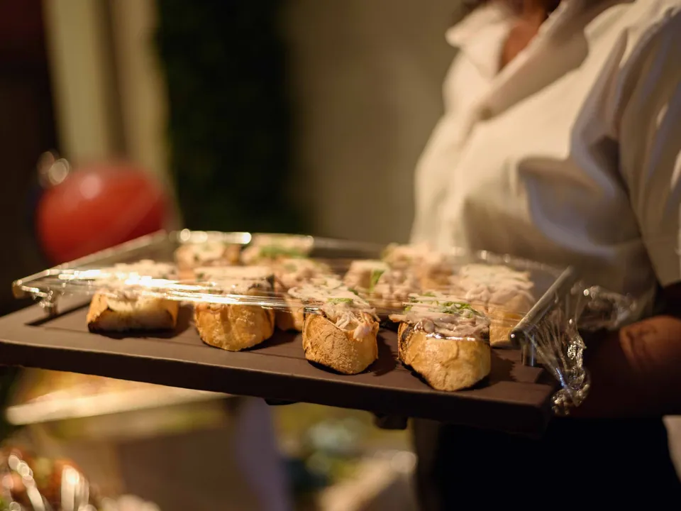 Waiter serving a tray of appetisers at a catered event in Enugu, Nigeria